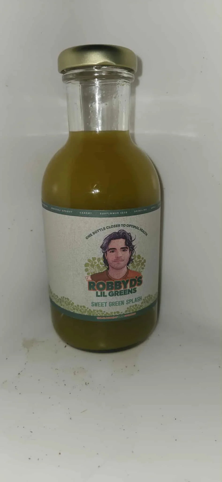 Robby Ds Sweet Mango Splash organic microgreen broccoli drink bottle with green label and natural fruit flavoring
