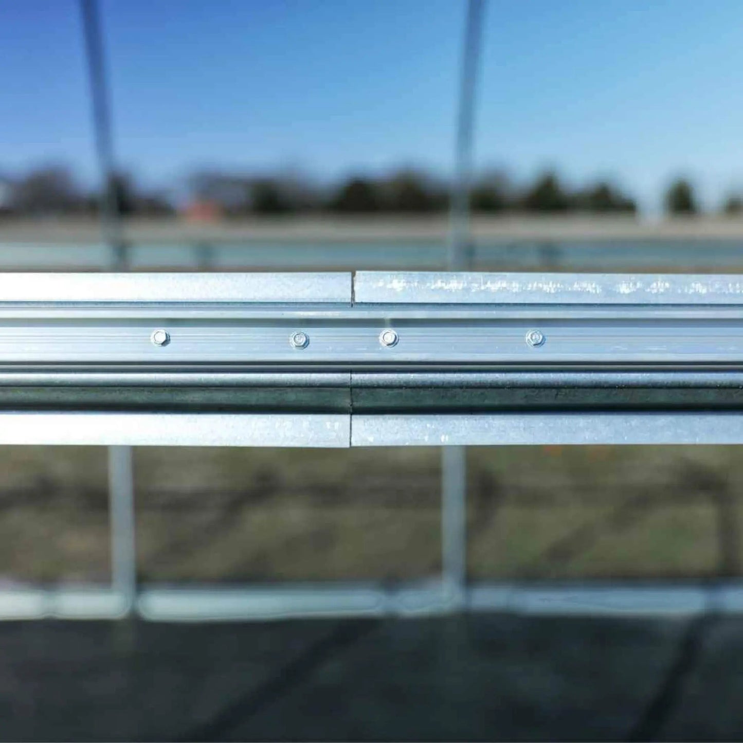Close-up of aluminum lock channel for greenhouse or hoop house frame installation outdoors
