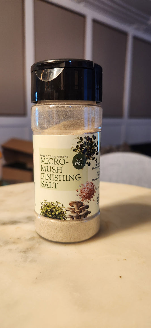 Robby Ds Lil Greens organic microgreen and mushroom finishing salt blend in clear container with green herbs visible